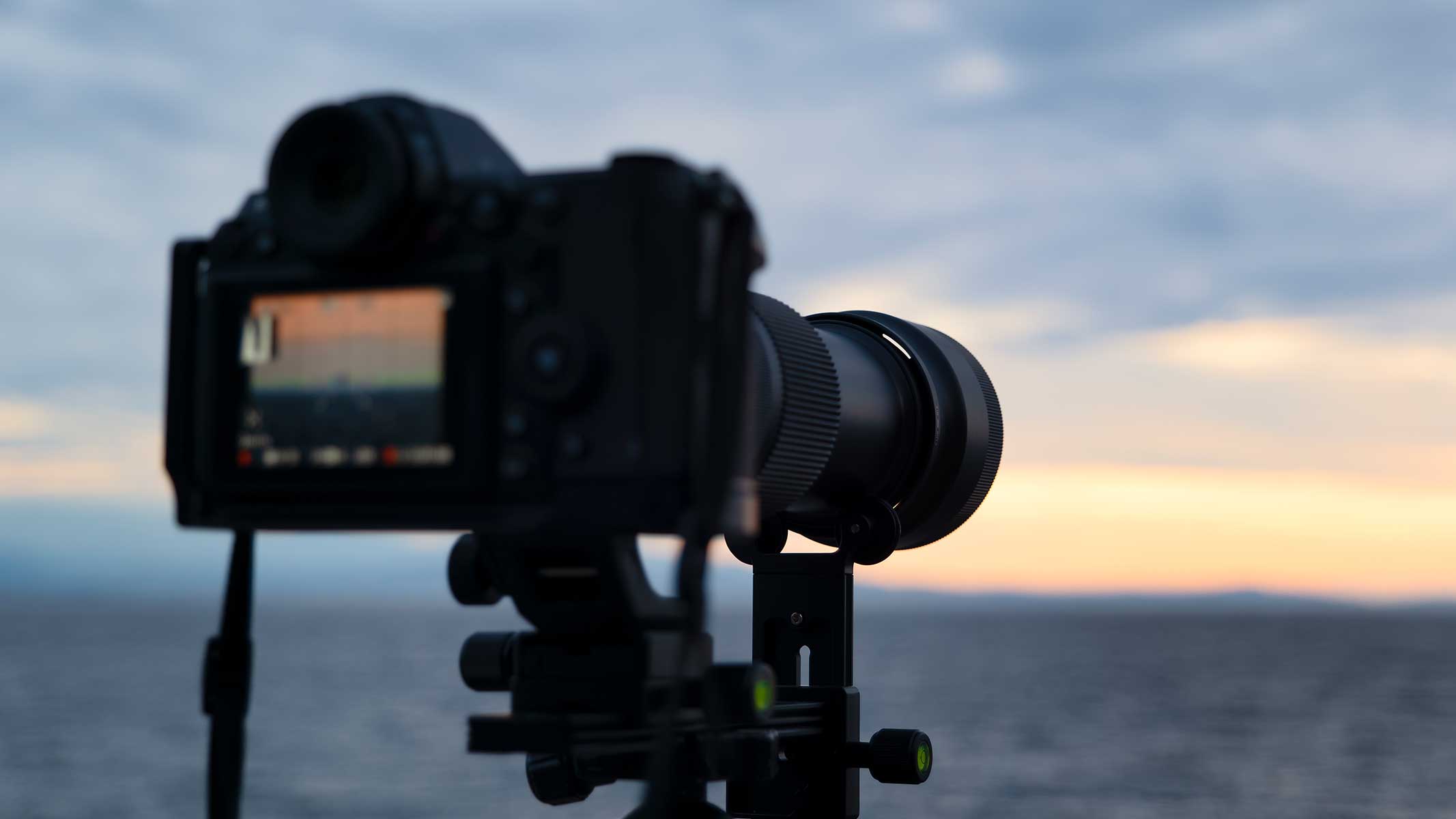 Mirrorless camera on a tripod at dusk