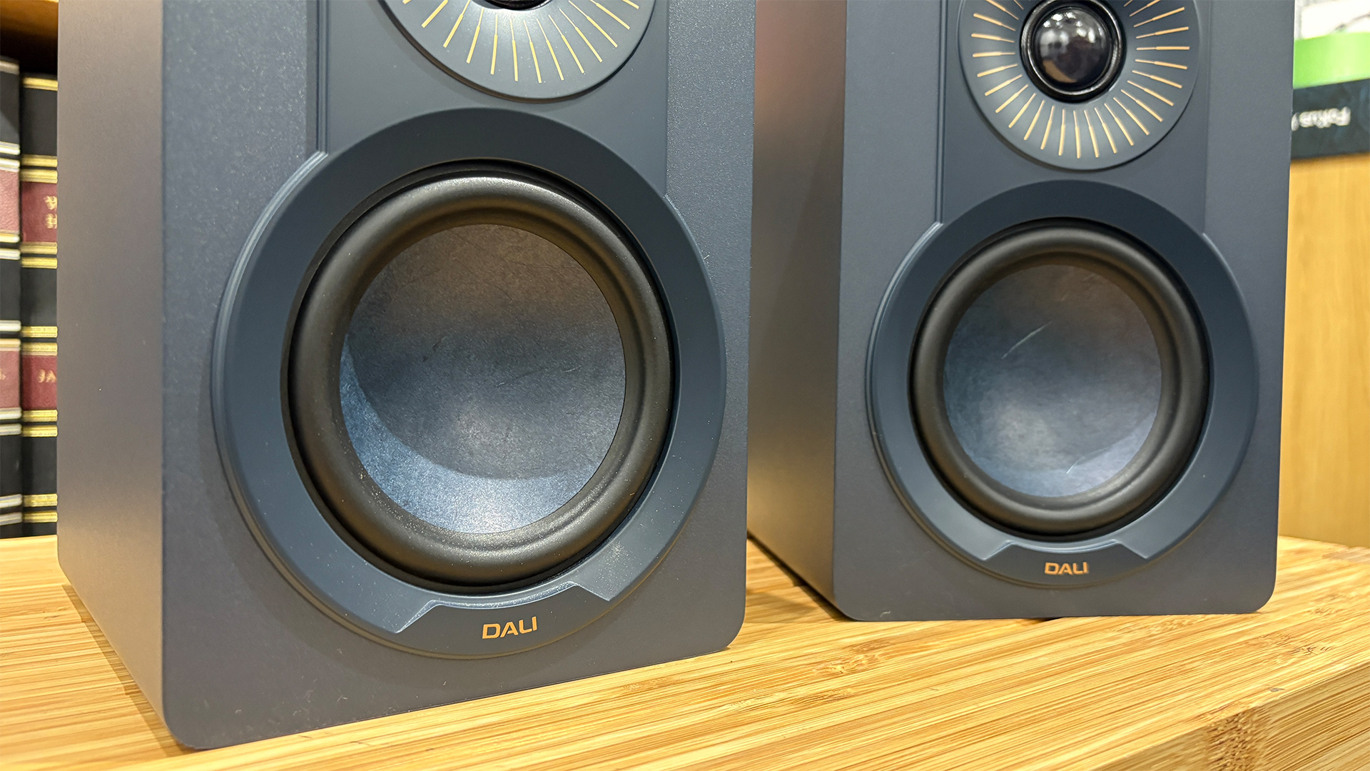 Dali Kupid standmount speakers on wooden hi-fi rack, detail of mid/bass units
