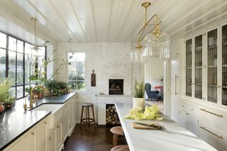 Light filled white kitchen with glass chandelier