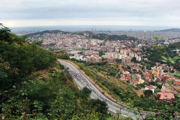 The peloton climbs out of Barcelona at the beginning of stage seven.