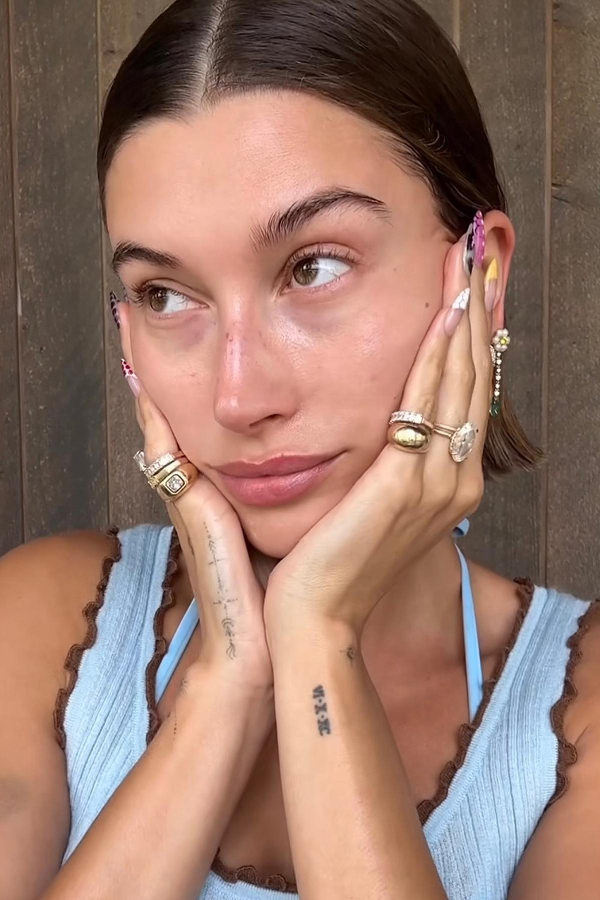 A woman wearing gold stacked rings