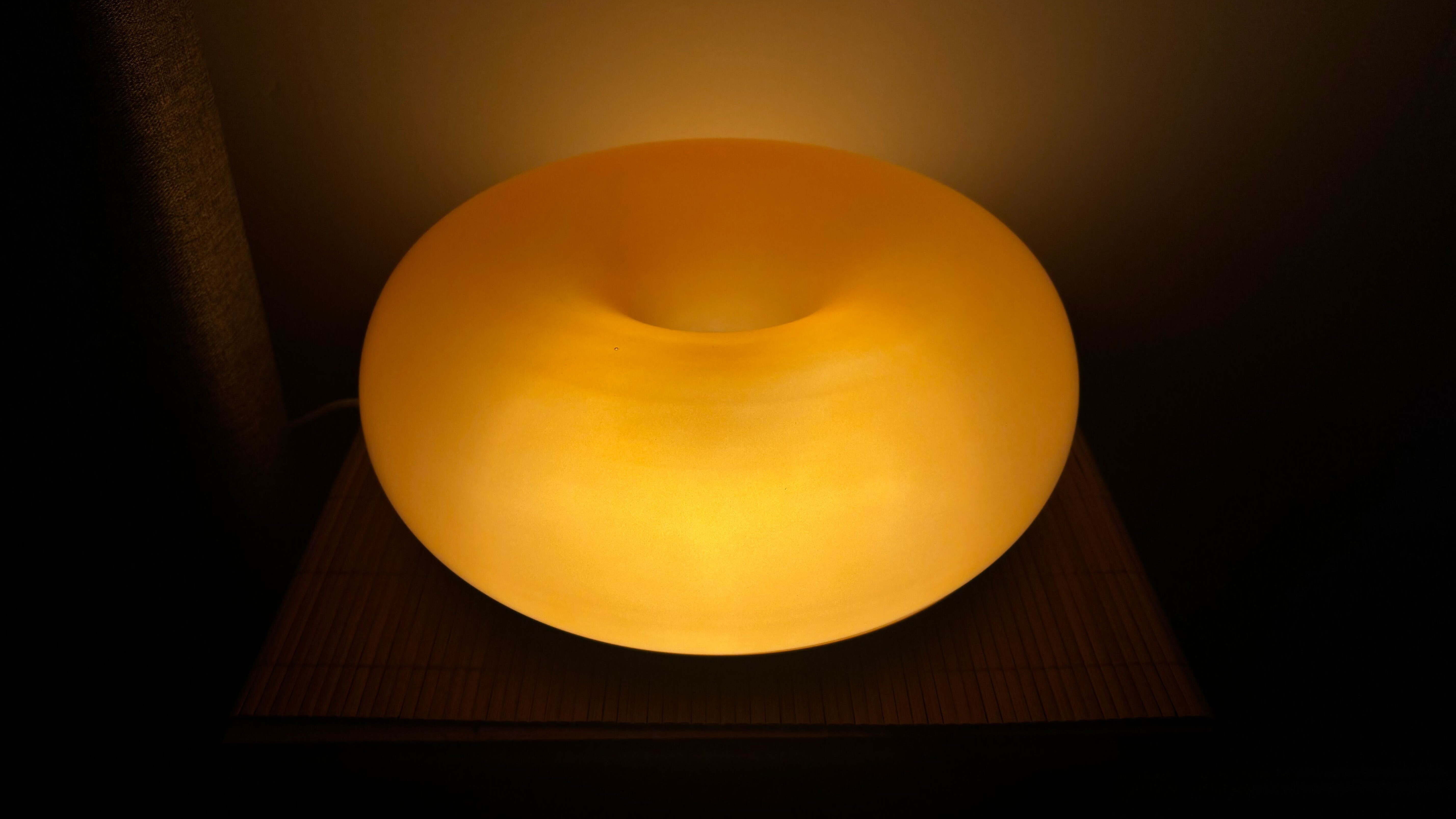 The IKEA Varmblixt lamp on a bedside table in a dark room