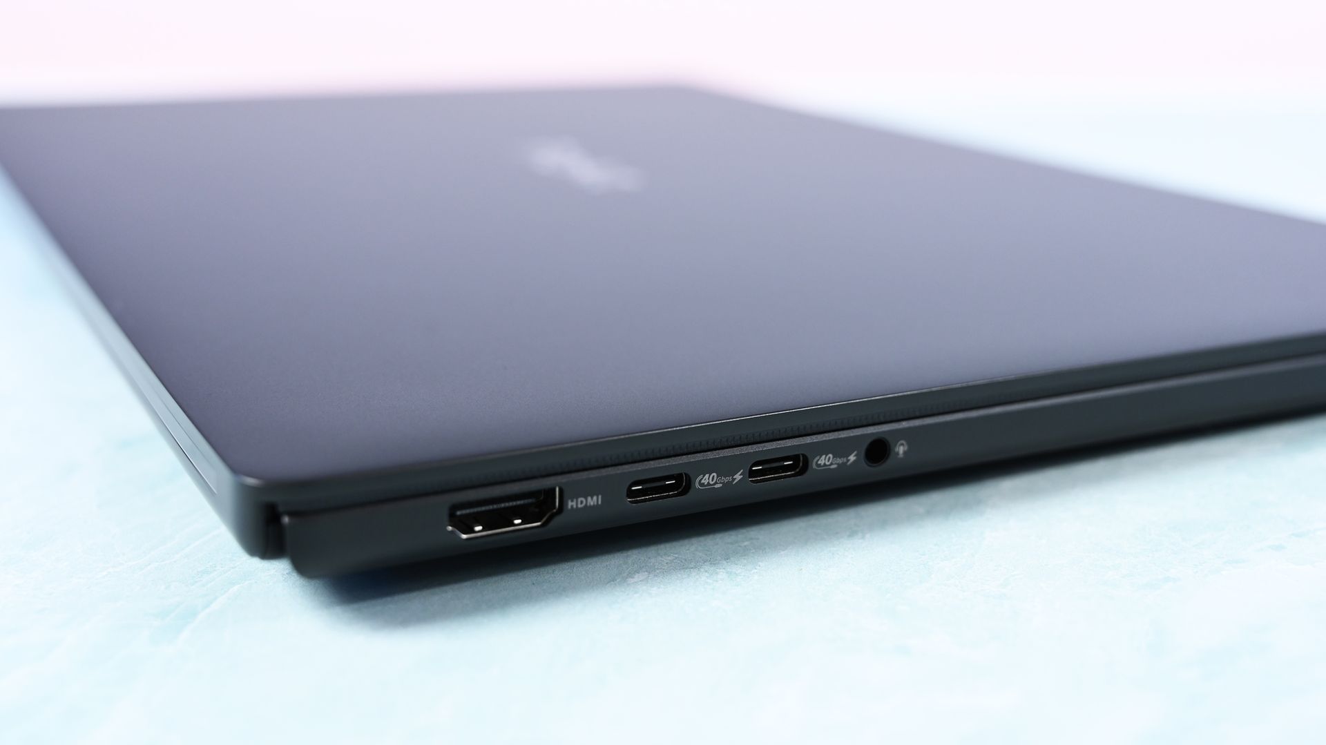 Close-up of the left edge ports: an HDMI port, two 40Gbps USB-C ports, and a 3.5mm headphone audio jack.