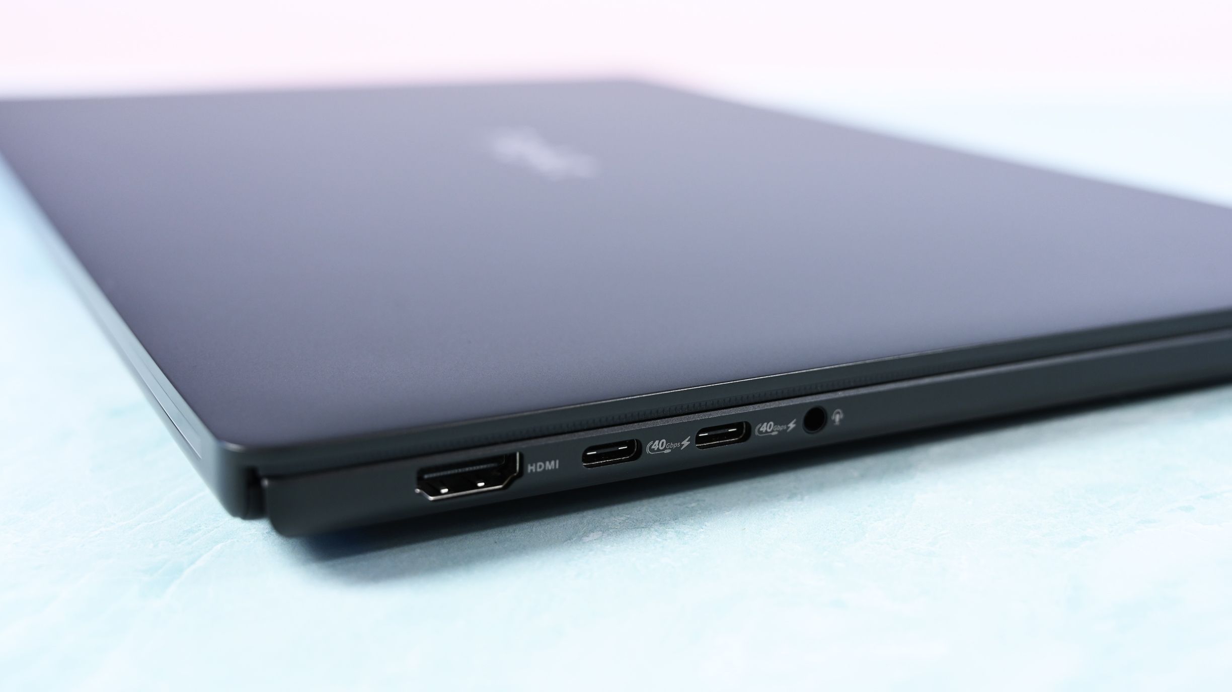Close-up of the left edge ports: an HDMI port, two 40Gbps USB-C ports, and a 3.5mm headphone audio jack.