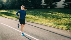 Woman running after gait analysis wearing running shoes along sunny road