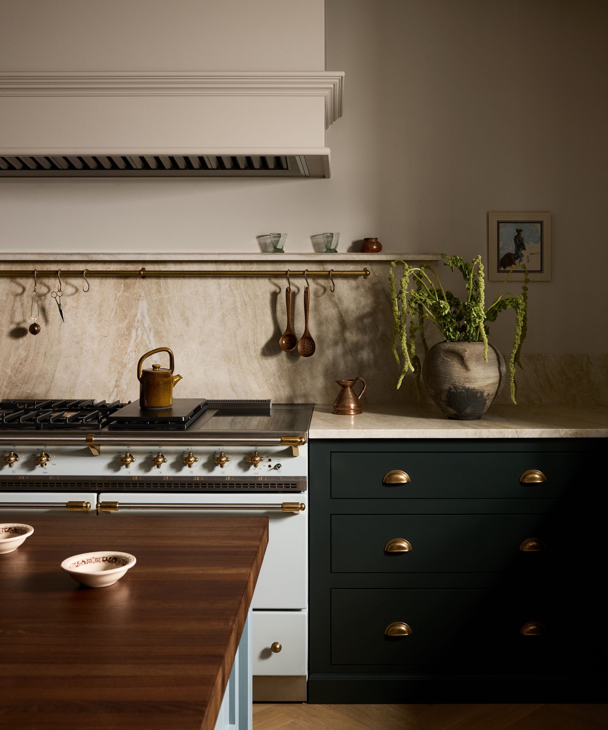 a muted earthy kitchen with dark deVOL cabinetry, and a large white rangecooker with boxed in hood