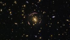 Hubble captured this image of the universe's many galaxies, with an Einstein ring to boot. When the light from distant galaxies warps around an extremely large mass, like a galaxy cluster, it creates this elegant ring.