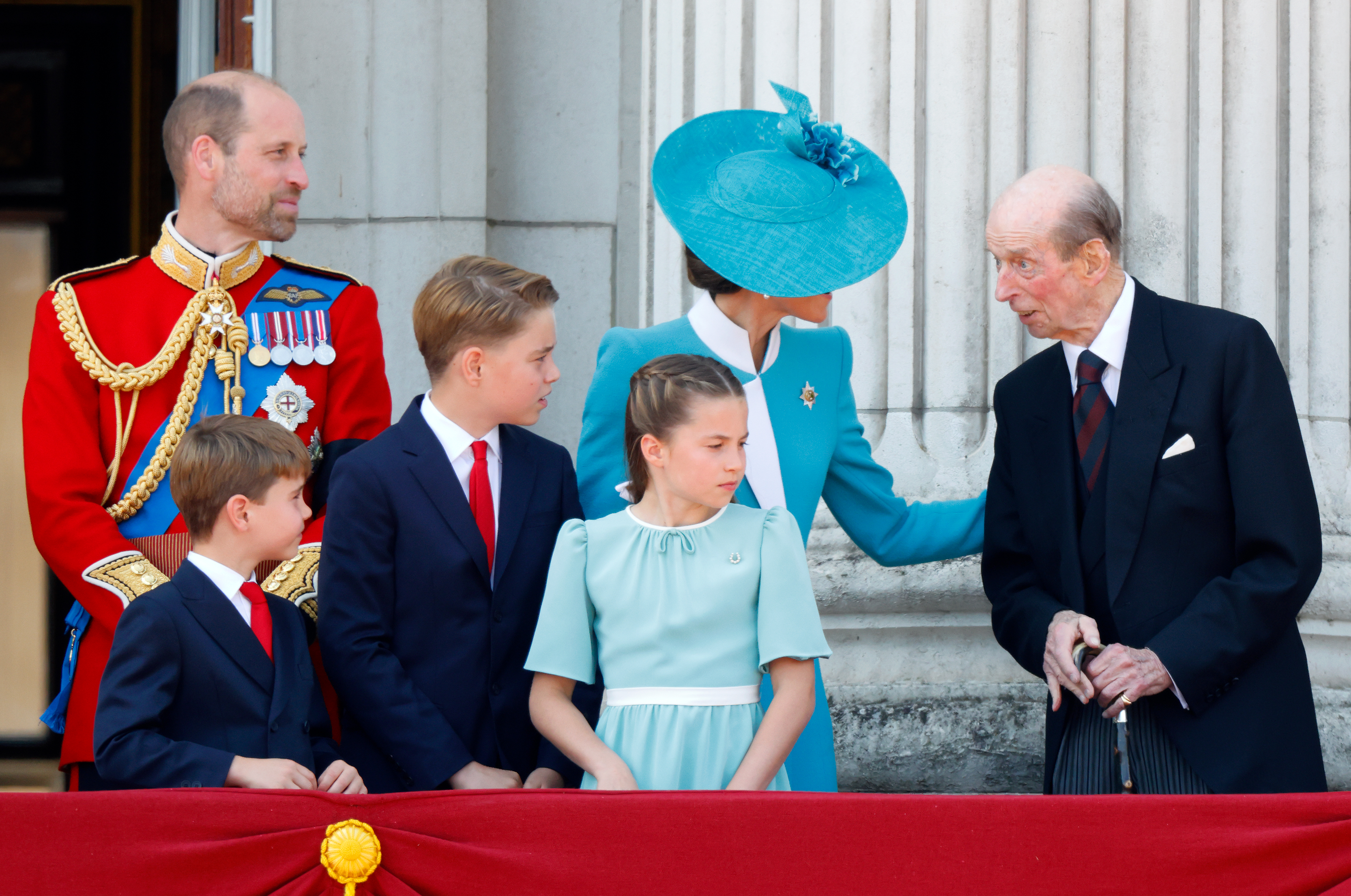 Prince William and Princess Kate talking to the Duke of Kent on the balcony of Buckingham Palace