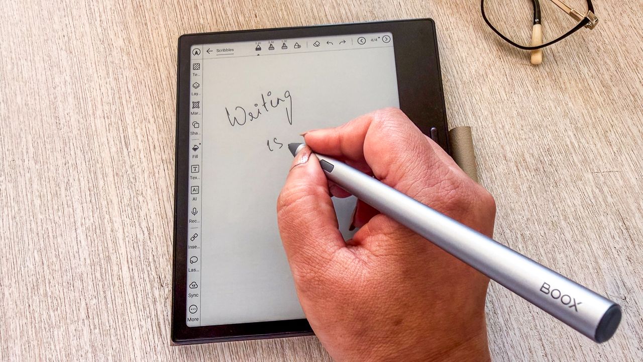 A person using the InkSense Plus stylus to write on the Boox Go 7