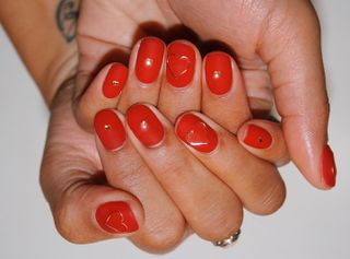 woman wearing Red nail polish