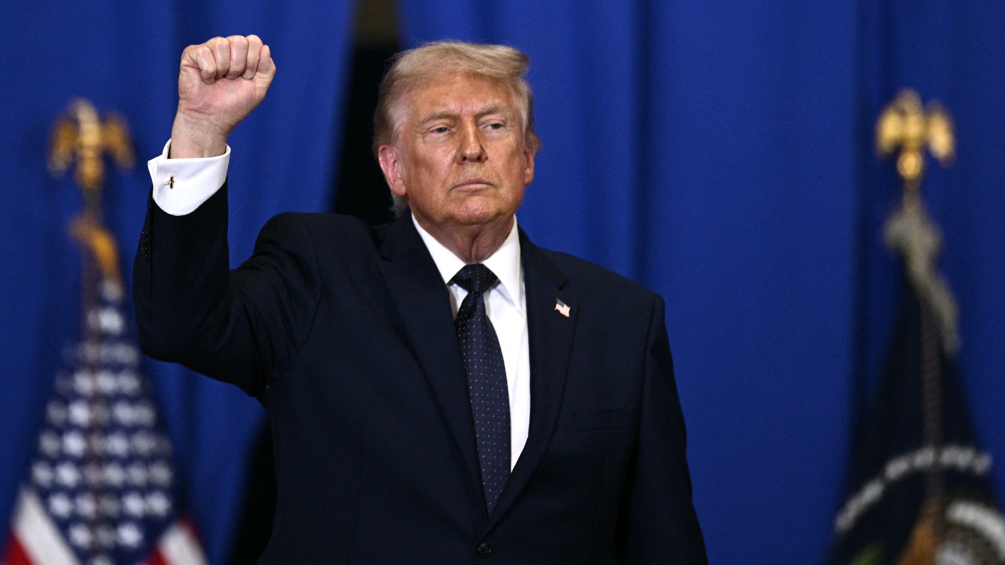 Trump raises his fist in the air