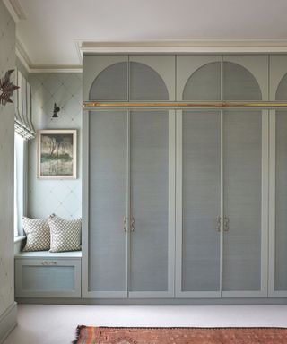 bedroom cupboards with arched fabric panels on doors