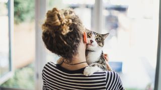 Do air purifiers help with allergies?: image of woman and cat