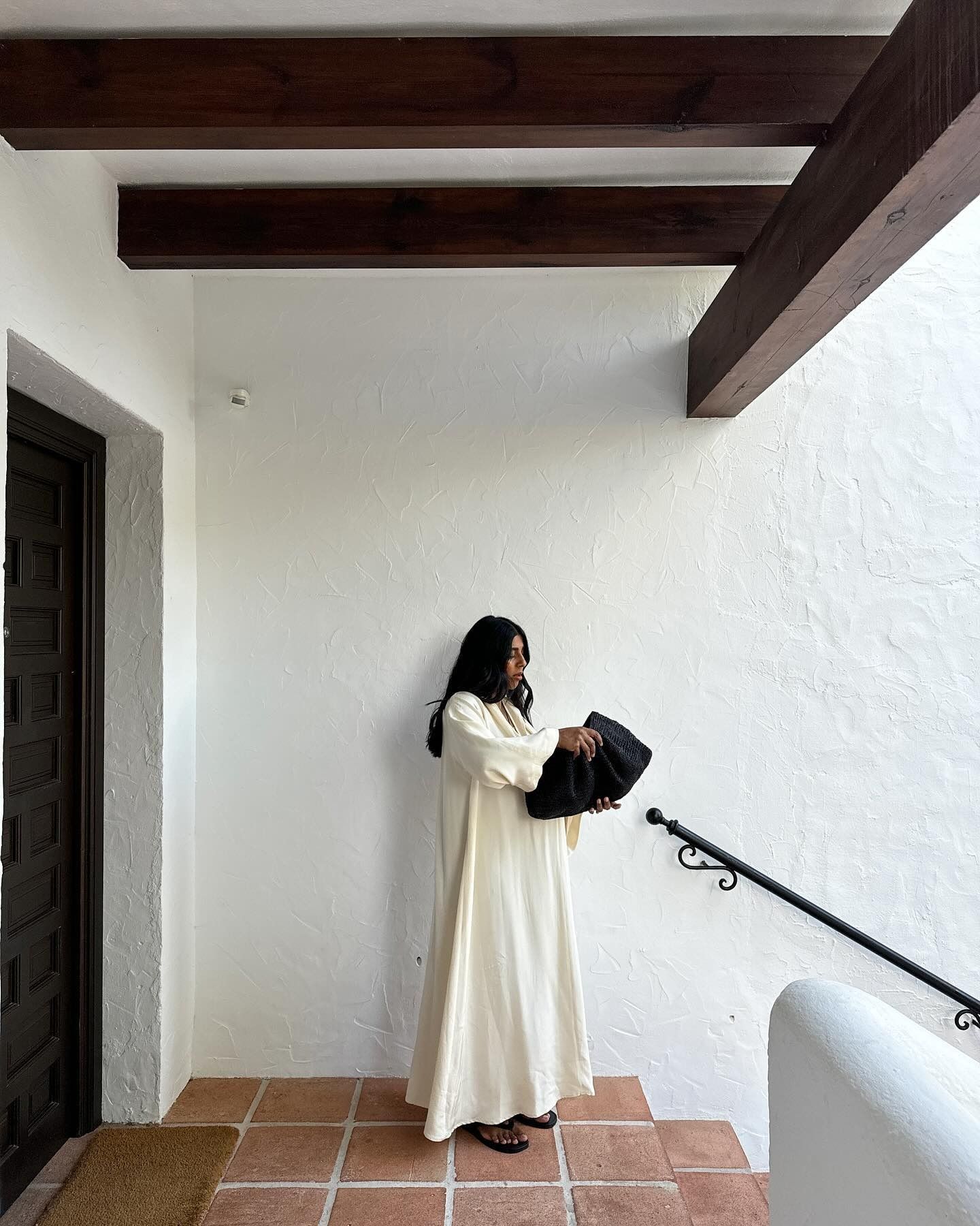 Monikh wears a white kaftan on holiday.