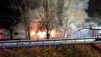 A train in New York is on fire after colliding with a car.
