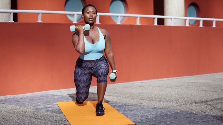 Woman doing a lunge with weights