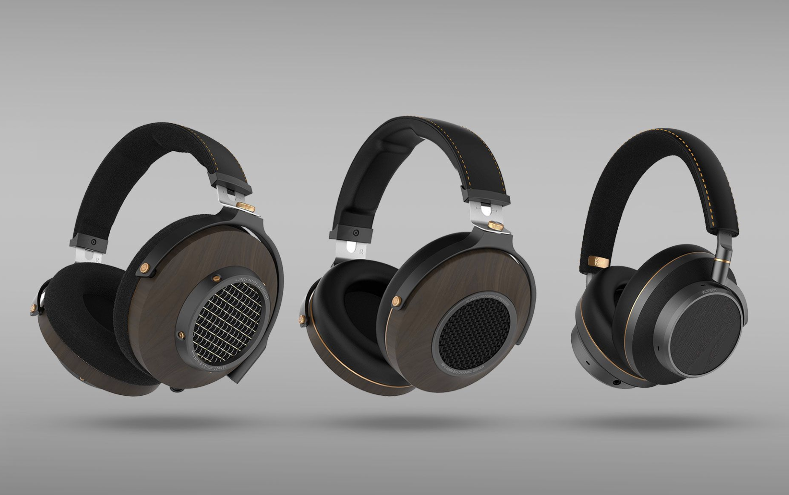 Klipsch Atlas series: three pairs of gorgeous headphones elevated from the ground, on a gray background