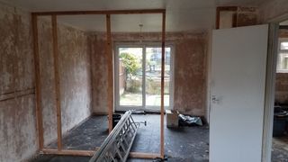A studwork wall inside a newly plastered room
