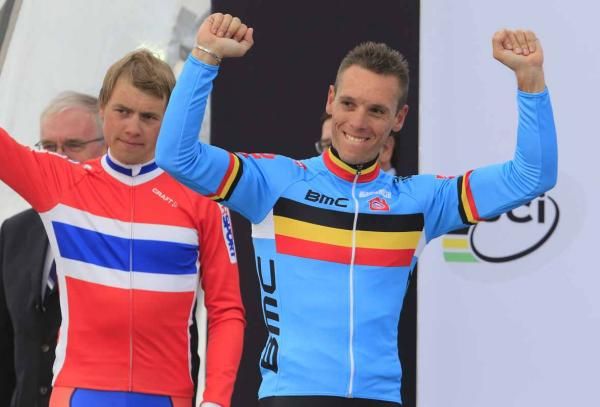 Gilbert celebrates as he prepares to pull on the rainbow jersey
