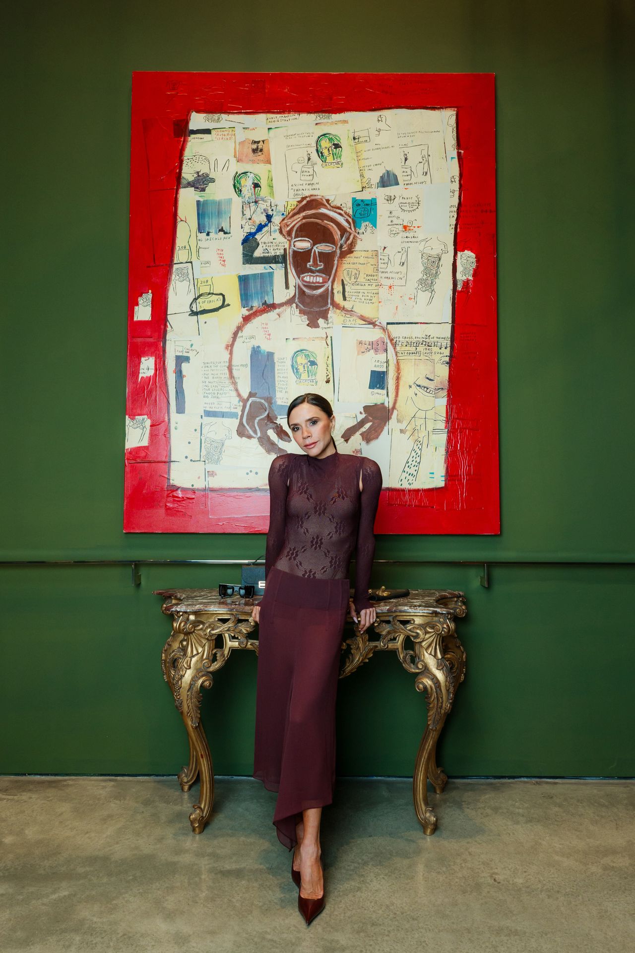 Victoria Beckham in front of Basquiat painting