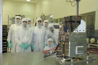 Members of the GOLD team pose in a clean room at the Laboratory for Atmospheric and Space Physics at the University of Colorado Boulder, after the instrument underwent a pre-ship review before being sent to Airbus Defense and Space in Toulouse, France.
