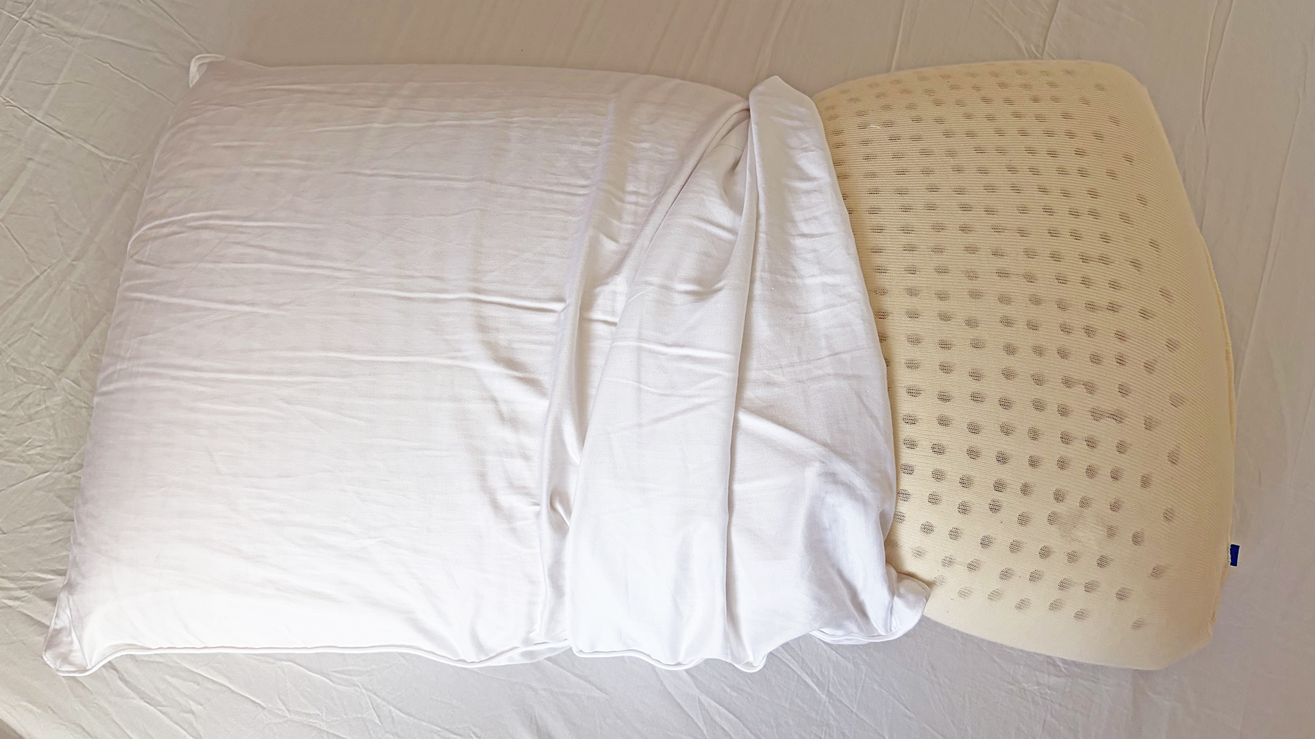 The Bearaby SoftForm pillow with the cover partly pulled back to show the foam interior