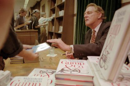 In this Aug. 21, 1995, file photo, Winston Groom, author of "Forrest Gump," the book on which the film was based, signs copies of "Gump & Co.," the sequel to "Forrest Gump", at a New York Cit
