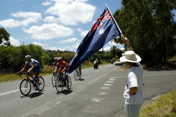 A fan cheers on the passing peloton