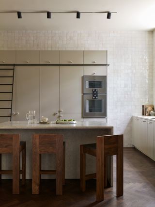 a kitchen wth zellige tiles behind the cabinetry on the walls