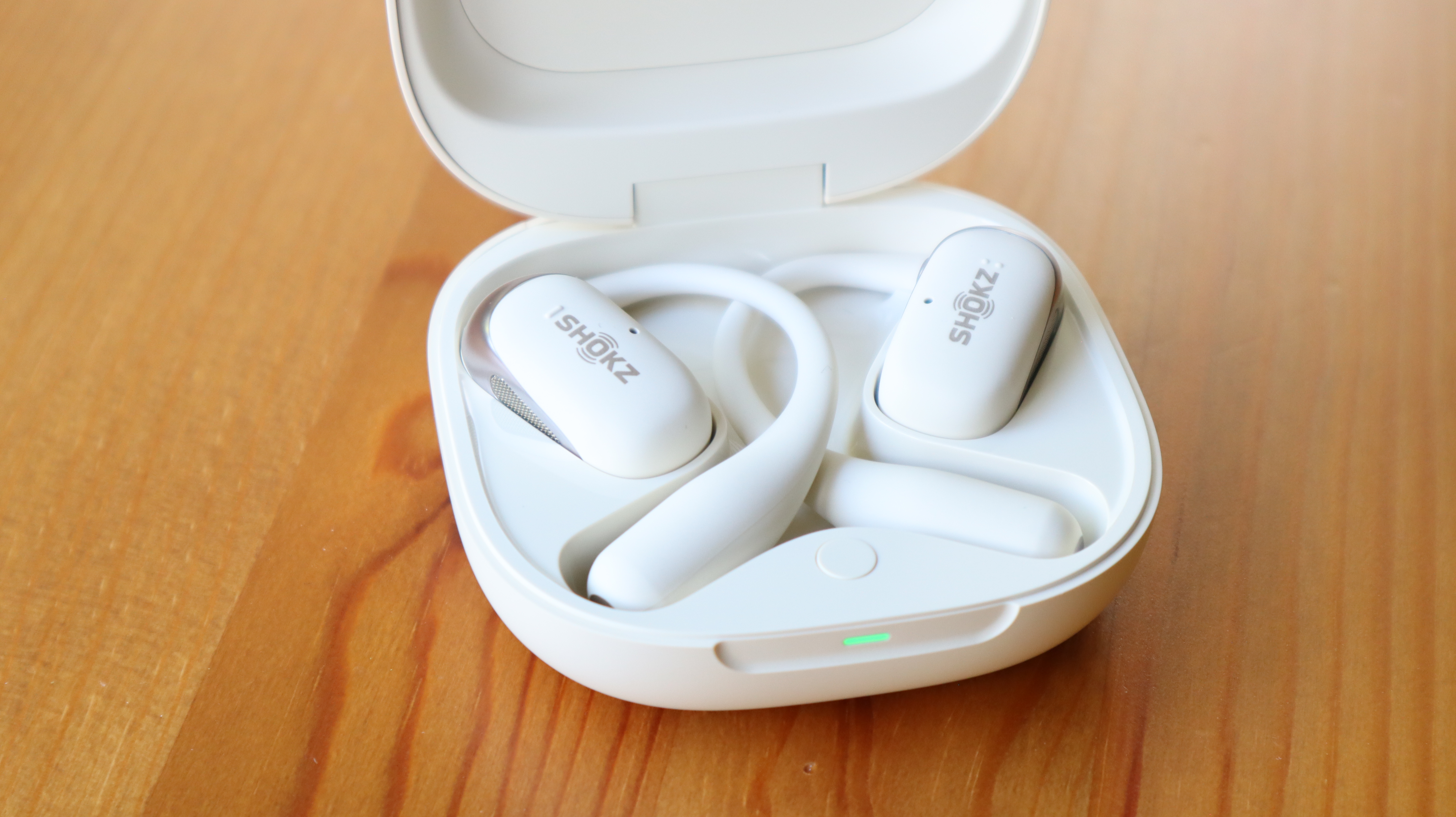 Shokz OpenFit 2 on a wooden table