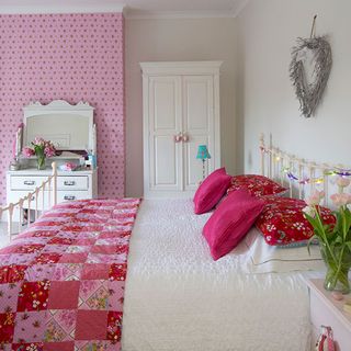 bedroom with bed and cushions quilt pips studio roses and dots wallpaper