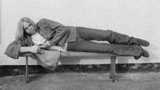 Rick Wakemen reclining on a bench