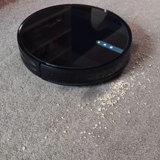 Image of Proscenic 850 cleaning up oats spilt onto carpet