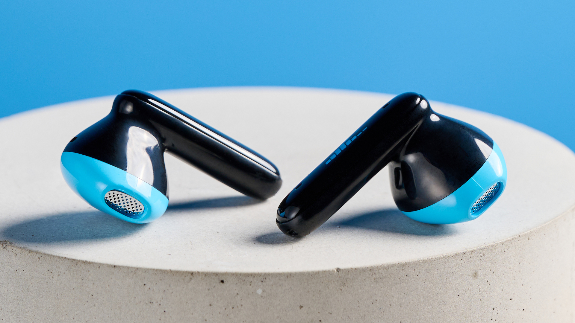 the h2o audio ript-lite earbuds in black and blue, photographed against a blue background, for both working out and everyday use