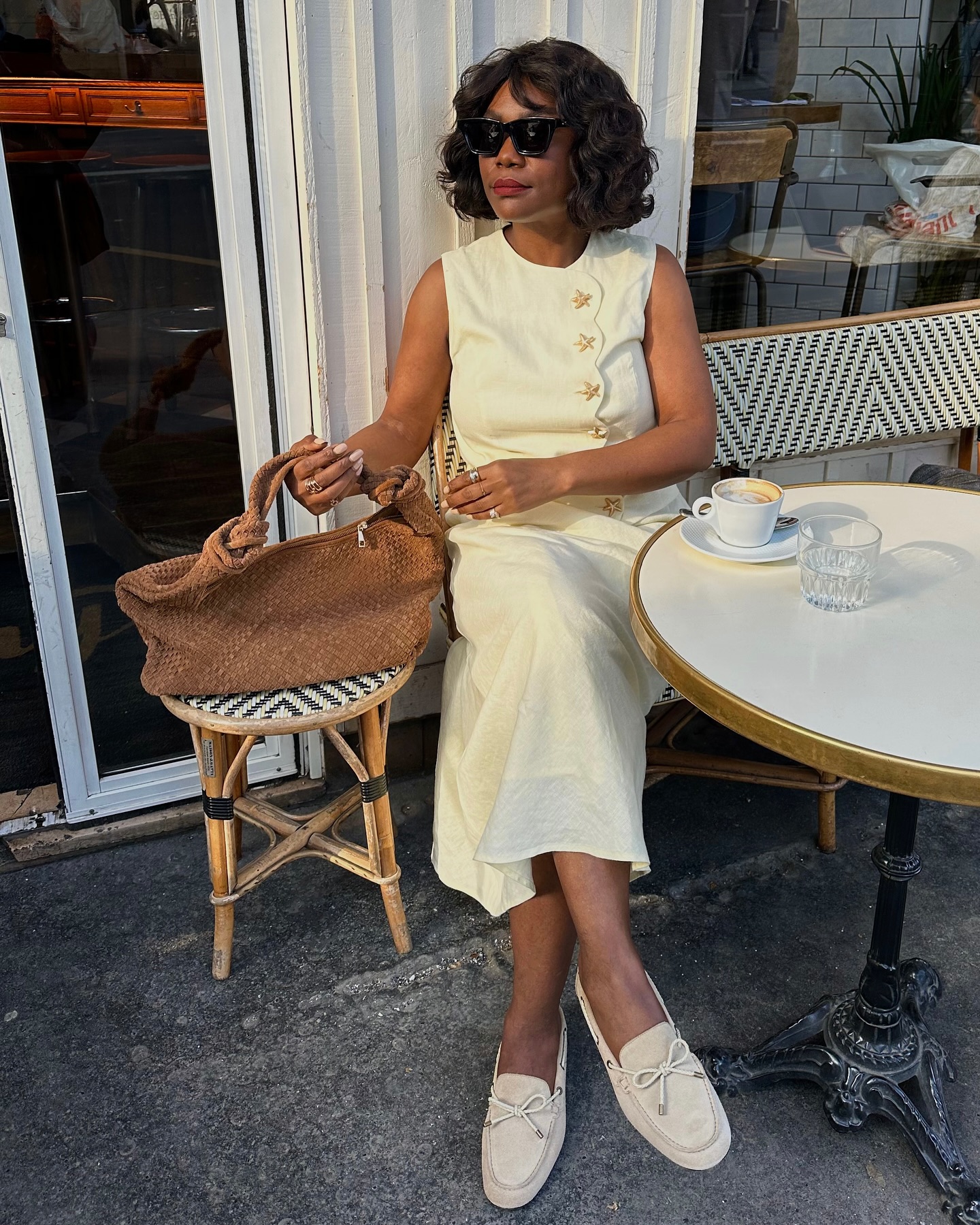 Woman in pale yellow linen set.