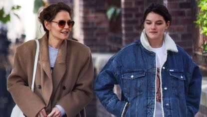 Katie Holmes and Suri Cruise walk in Manhattan wearing fall jackets including a camel coat and a denim trucker jacket