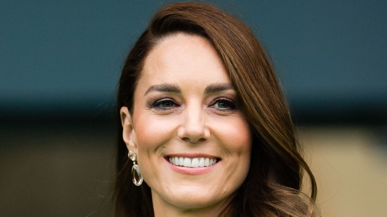 kate middleton in a blue dress smiling