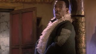 Eddie Murphy looking relaxed and leaning on a carved post in The Golden Child