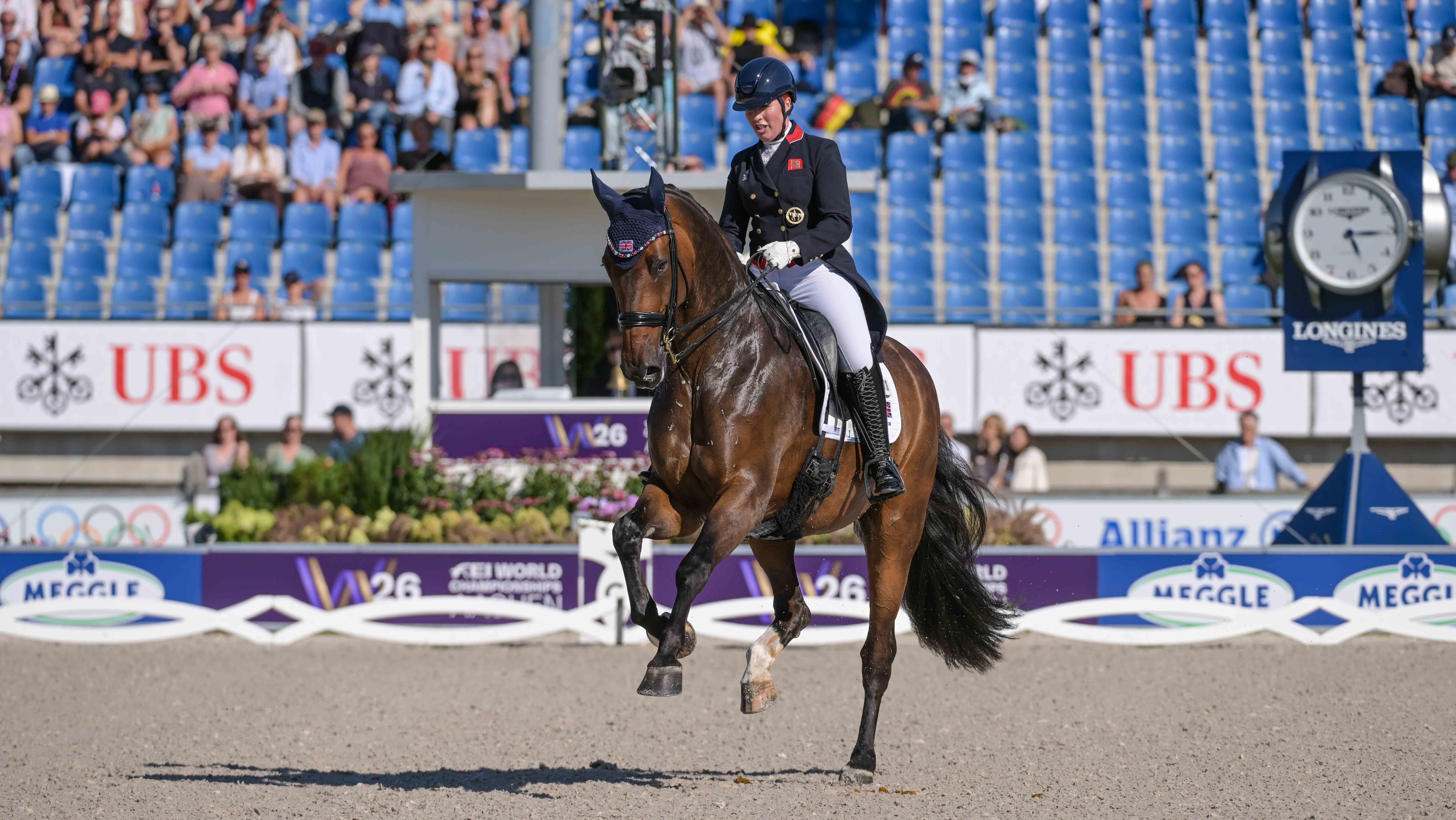 Becky Moody cantering across the diagonal with Jagerbomb at the 2026 Dressage World Championships in Aachen.