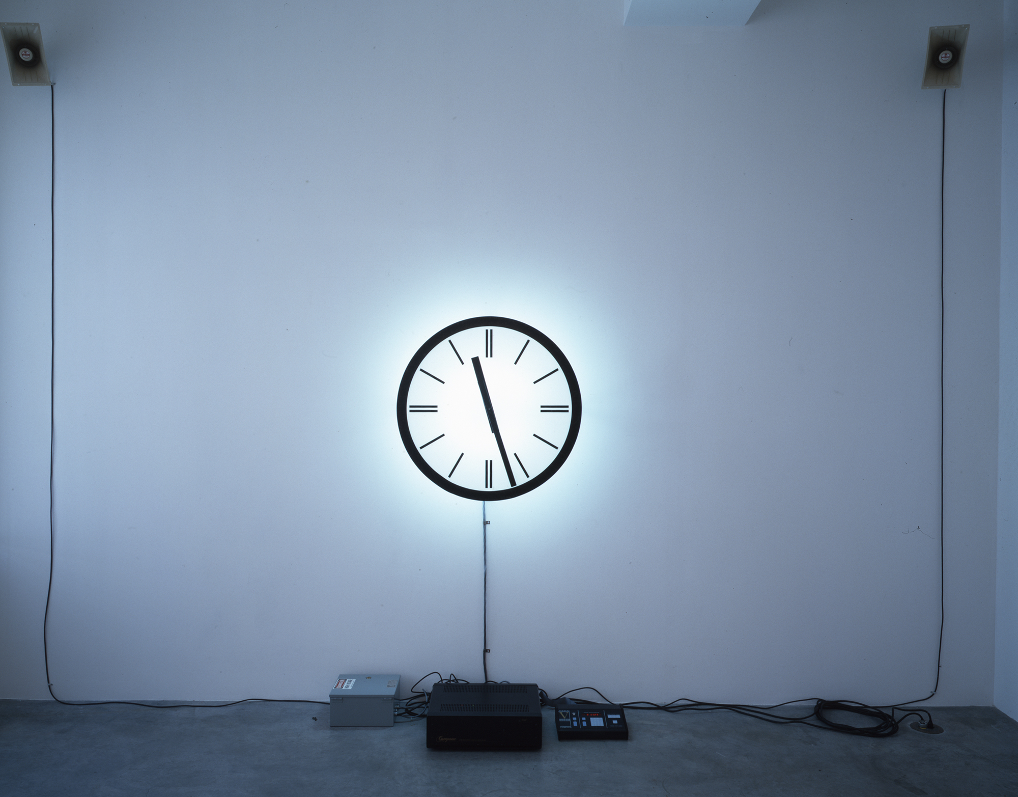 Clock on white wall as part of art installation