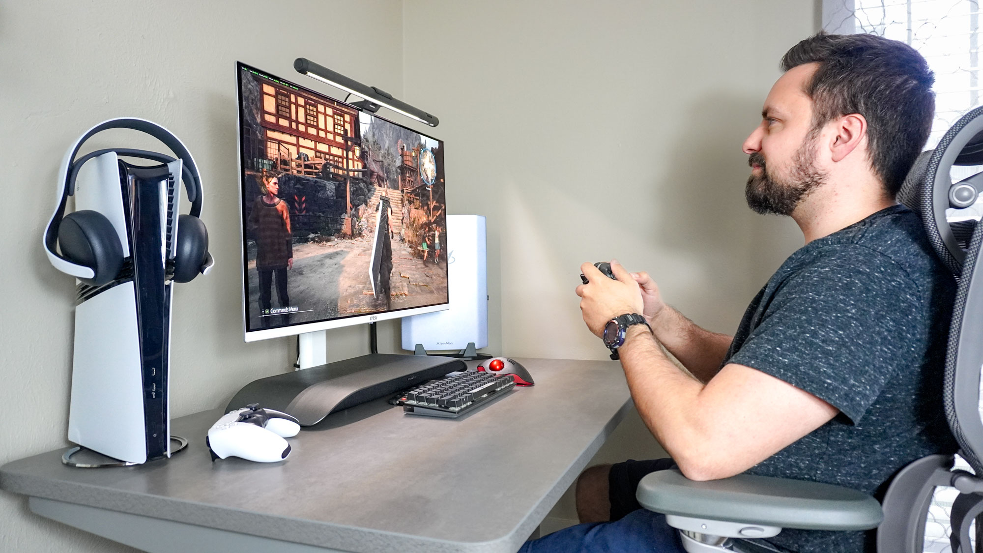 Playing games on the MSI MPG 321URXW QD-OLED monitor with audio from the BlueAnt Soundblade underneath it