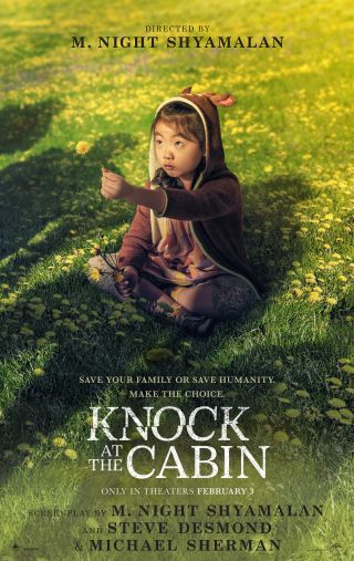 Kristen Cui offers some shadowy figures a flower, while sitting on the grass, in the Knock at the Cabin poster.