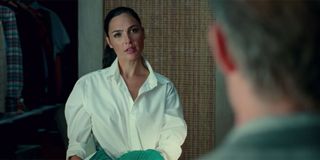 Wonder Woman looking at Steve Trevor while dressed in a white button up shirt.