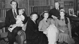 Emma Mary And Godparents After The Christening Today -- Left of right, Capt. Christopher Soames holding his son, Nicholas; Mrs. Duncan Sandys, daughter of Winston Churchill; Lady Rupert Nevill, godmother of the baby, Emma Mary Somes? whom she is holding; M. Andre de Staree, godfather of the child; and Mrs. Christopher Soames, the child mother, at the Christening reception today in the home of Capt. G. Soames, at Sheffield Park, Fletching, Sussex. Mr. Winston Churchill and Mrs. Churchill attended the christening of a grandchild today (Sunday) in the 13th century church at Fletching, Sussex.