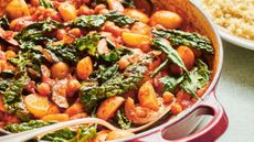 Bright orange stew with potatoes, chickpeas and green vegetables