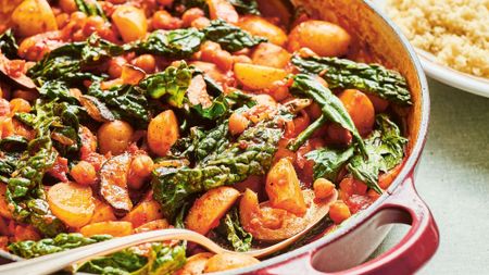 Bright orange stew with potatoes, chickpeas and green vegetables