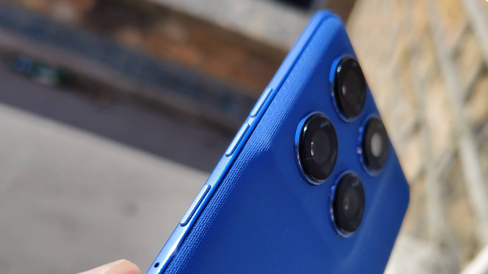 The Motorola Edge 60 Pro above a brick wall.