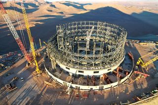 the skeleton of a half-finished round building in the desert