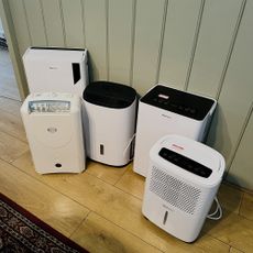 Five dehumidifiers being tested in a home with wooden flooring