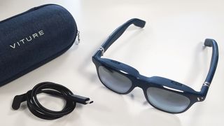 The Viture One XR glasses close up with case and cable.